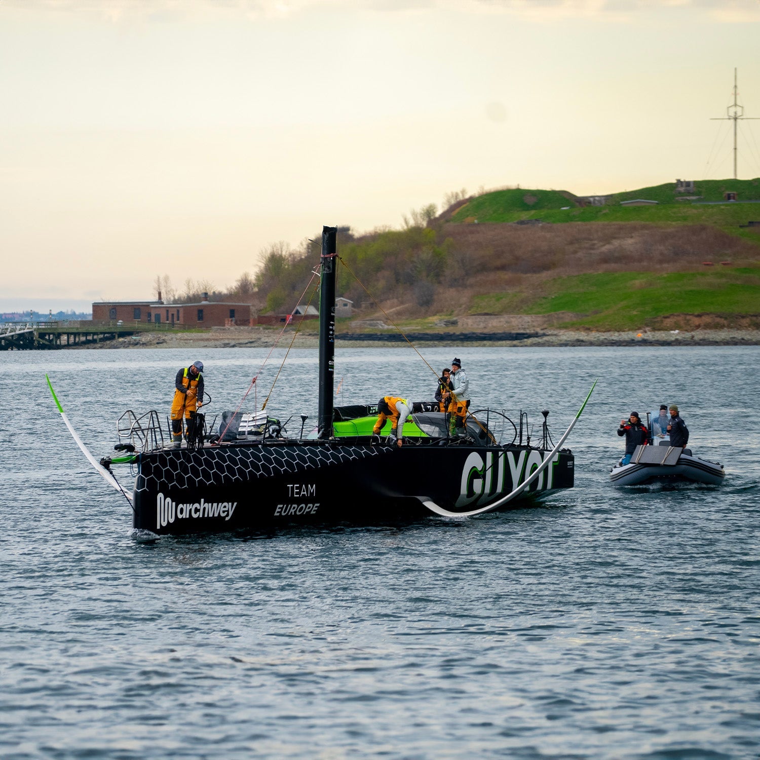 Square image of the Team Guyot boat being brought in to port after losing their rig at the end of Leg 4//© GUYOT environment - Team Europe | Charles Drapeau