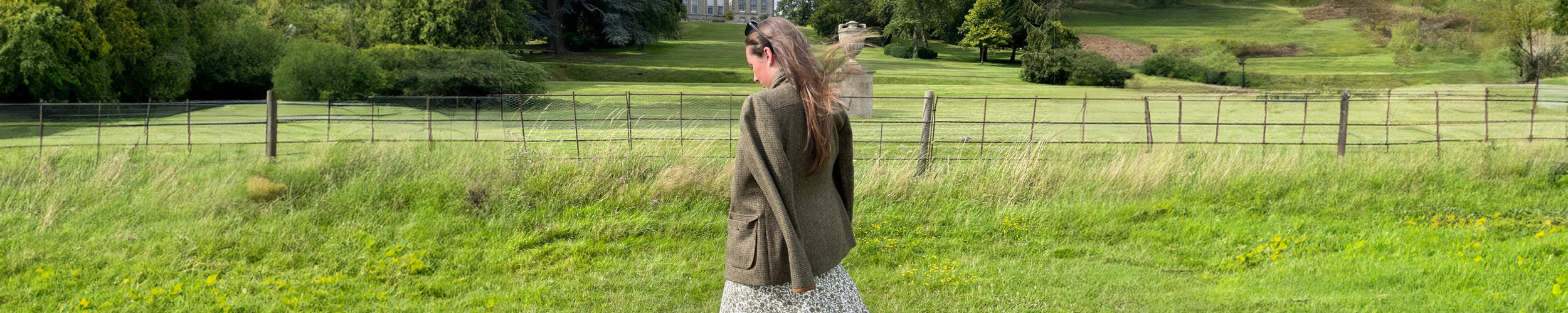 Wide image of Bonnie Baker in a tweed jacket dress and sunglasses at the Game Fair event in Ragley Hall.